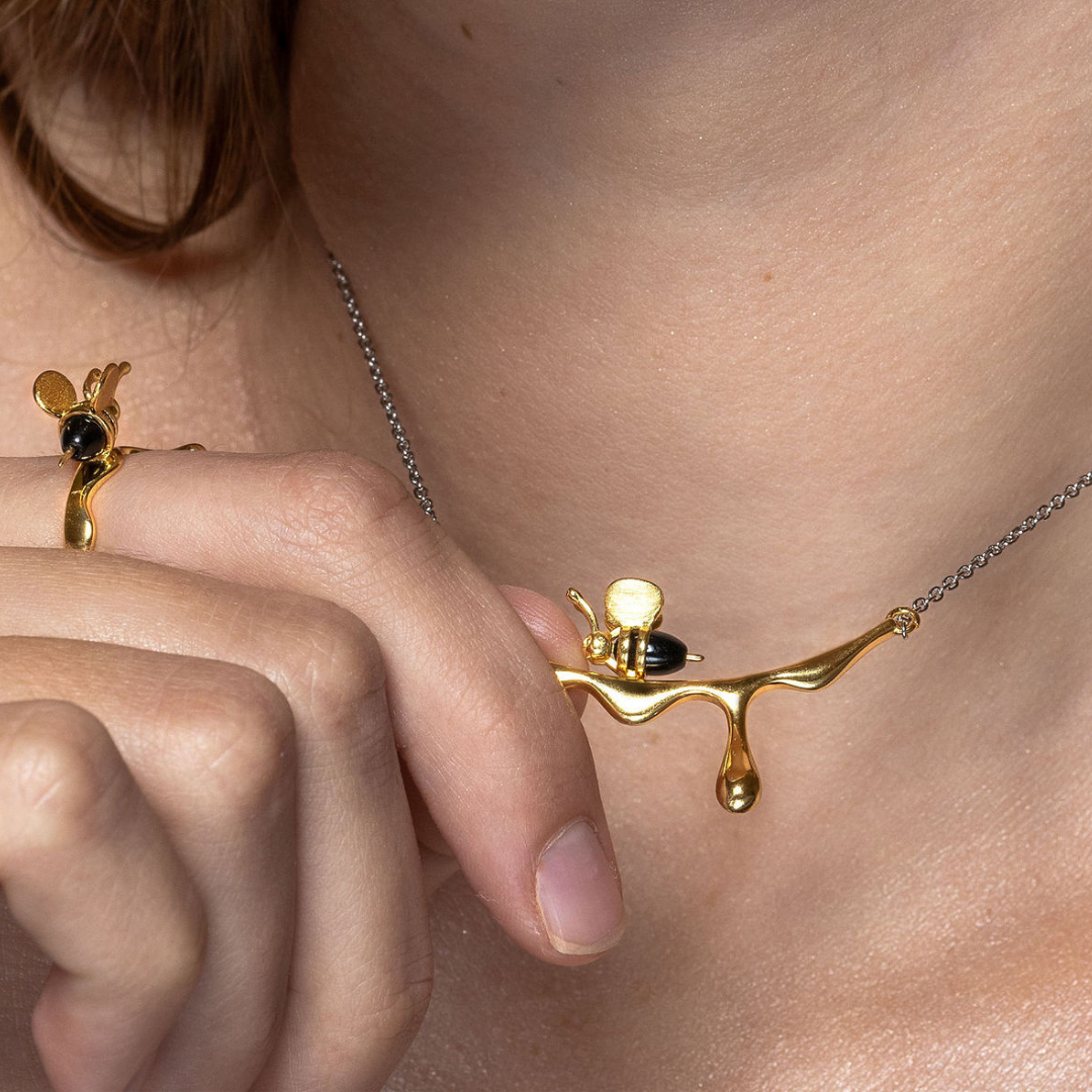 Unique bee and honey drop necklace in gold and silver tones









