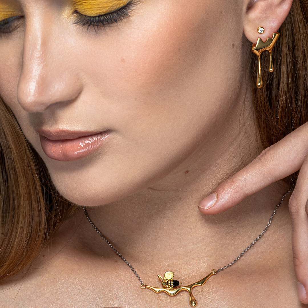 Artistic honey-themed necklace featuring gold bee detail

