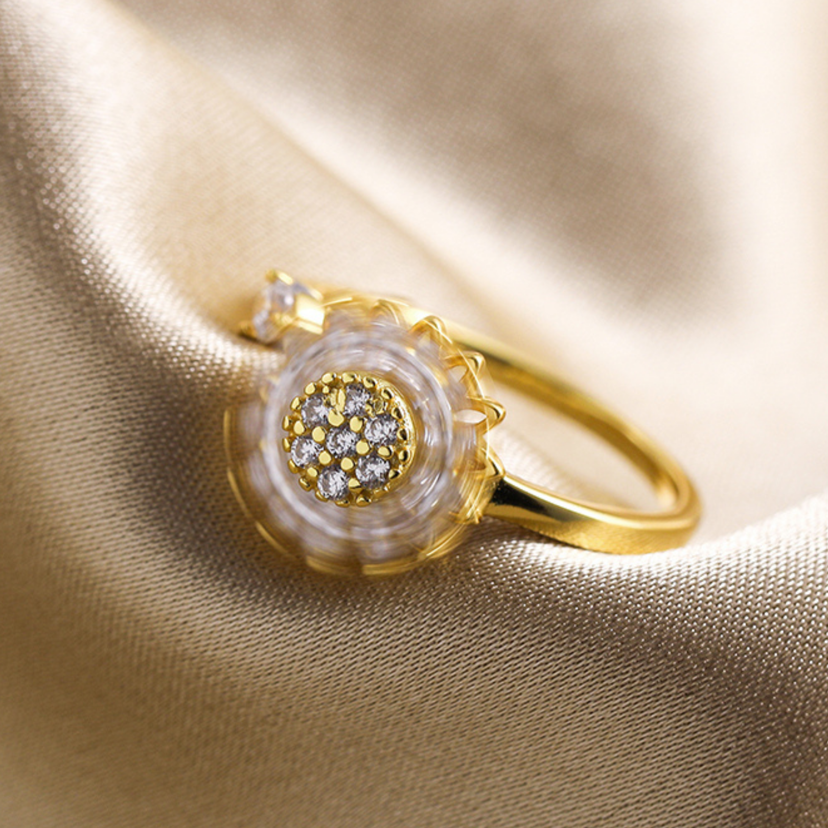 Gold sunflower jewelry piece featuring clear gemstone petals


