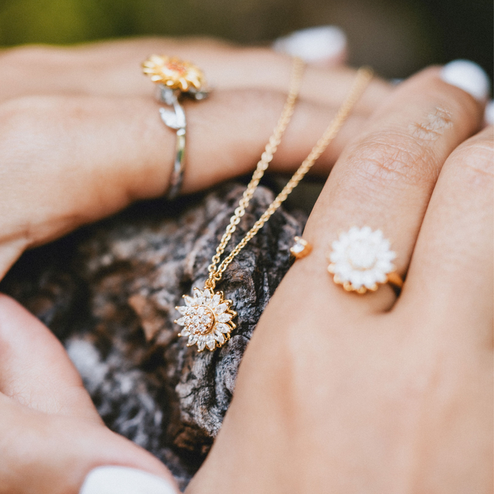 Dainty gold open ring with sunflower and diamond-like embellishments









