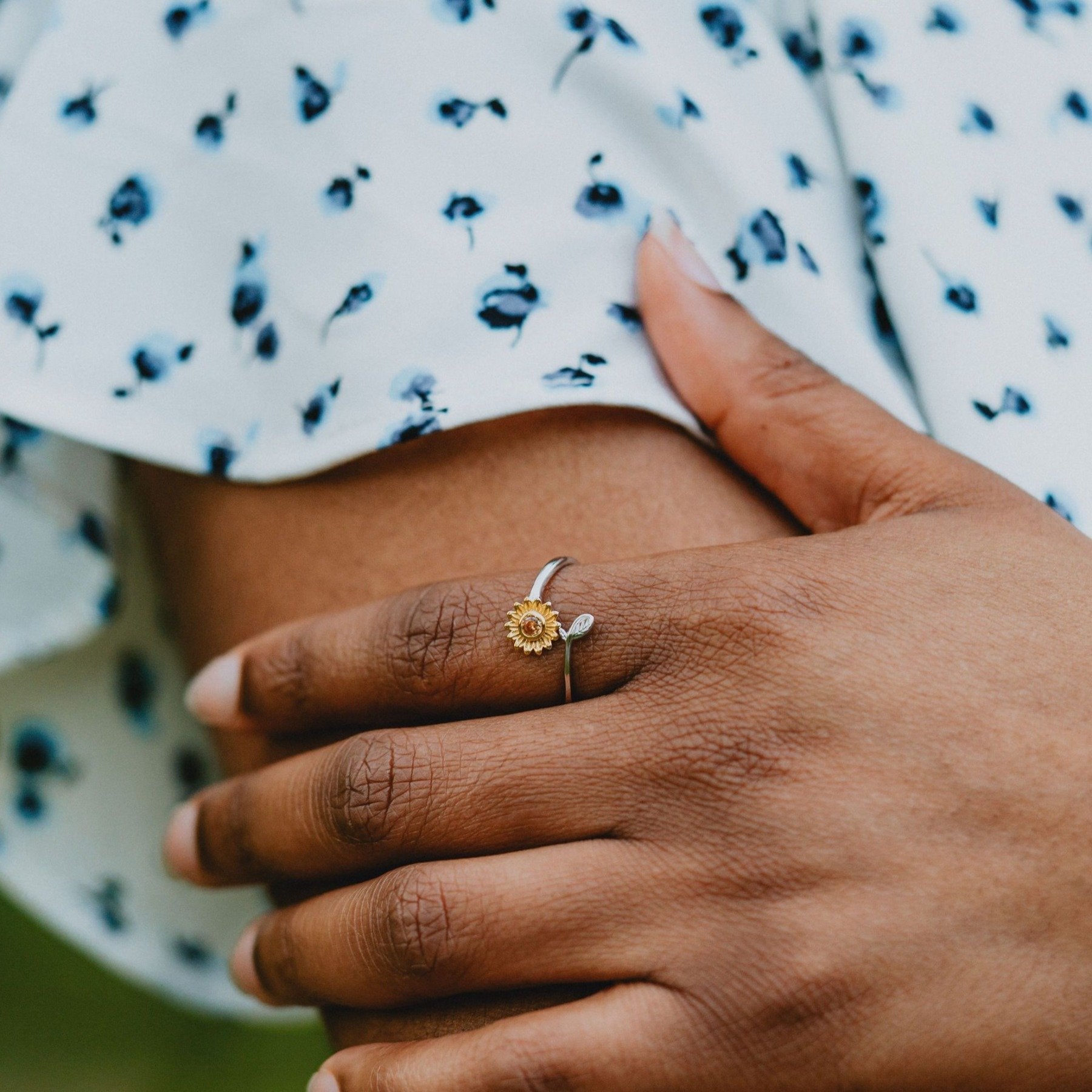 Two-tone sunflower ring in silver and gold with gemstone center

