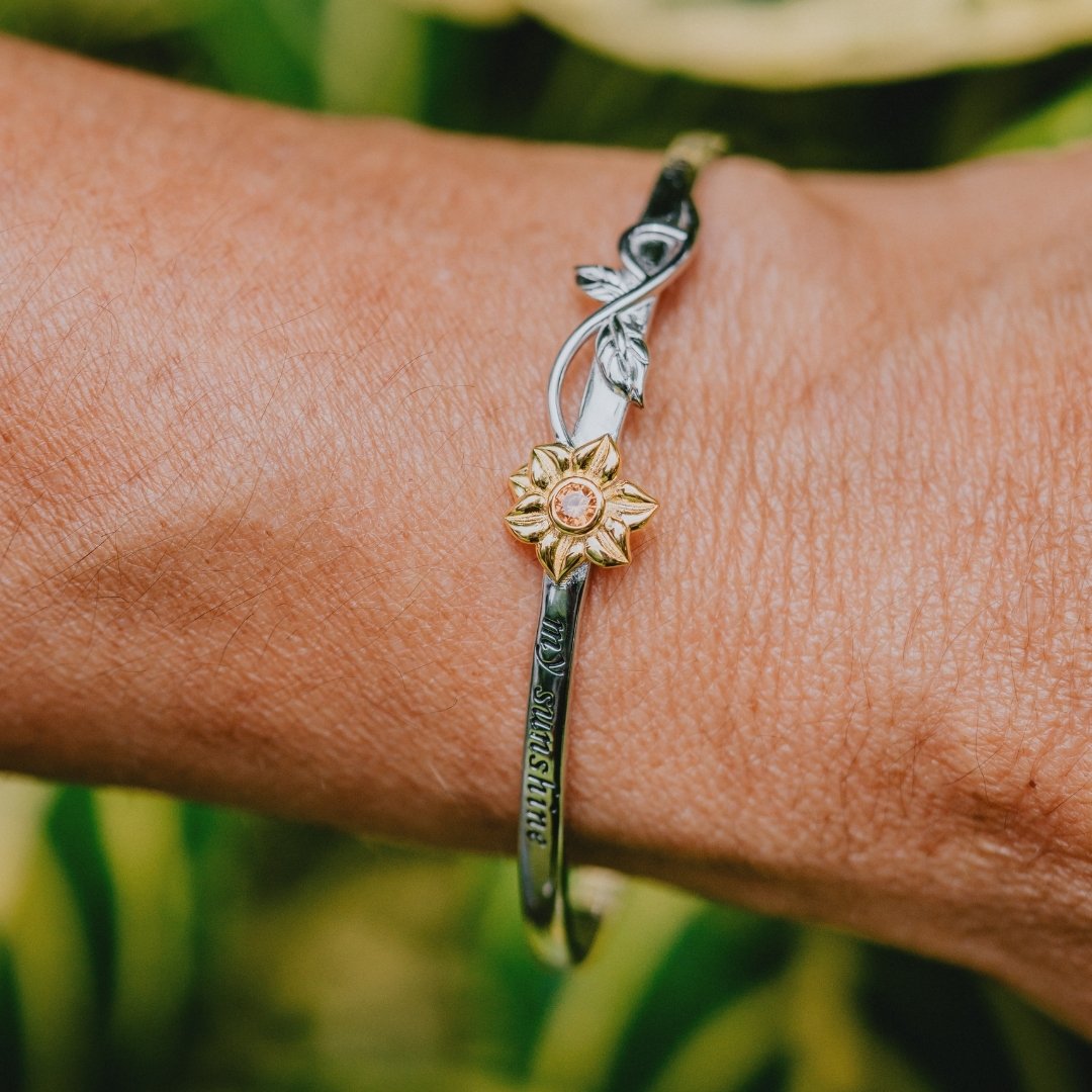 Adjustable sunflower charm bracelet with infinity design and gold accents

